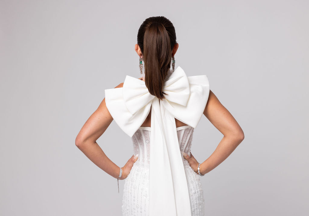 Off-white beaded Italian satin gown, halter jeweled neckline with large double cascading bow