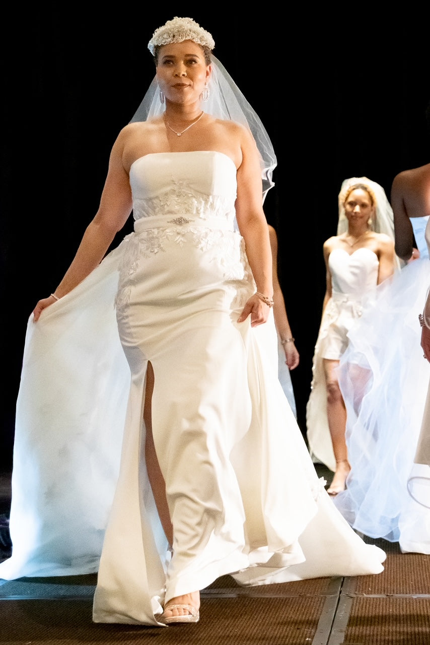 Off-white strapless Italian satin gown with embroidered lace detail; embroidered dramatic long detachable train.