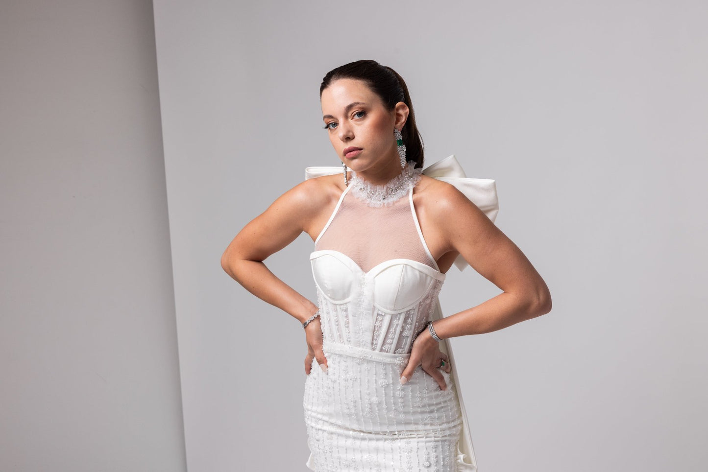 Off-white beaded Italian satin gown, halter jeweled neckline with large cascading double bow in the back.