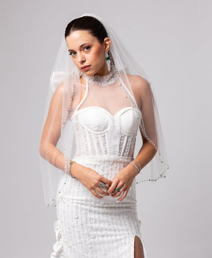 Off-white beaded Italian satin gown, halter jeweled neckline with large cascading double bow in the back.