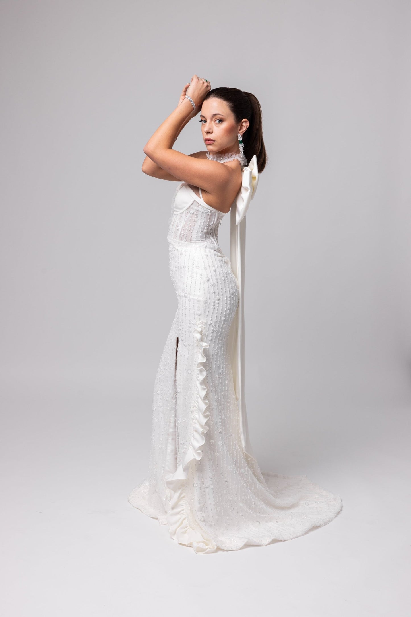 Off-white beaded Italian satin gown, halter jeweled neckline with large cascading double bow in the back.