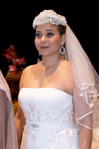 Off-white strapless Italian satin gown with embroidered lace detail; embroidered dramatic long detachable train. 