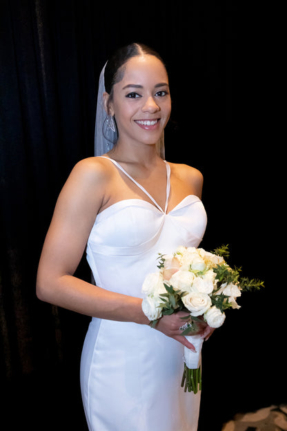 Chic halter gown with structured bust details and flared mermaid hemline with exposed tulle