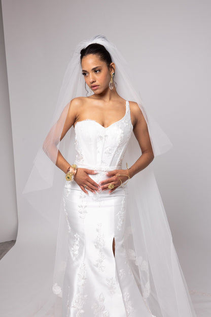 Off-white Mikado gown with embroidered lace, one shoulder with tulle detail over left bust.&nbsp; Detachable peplum.