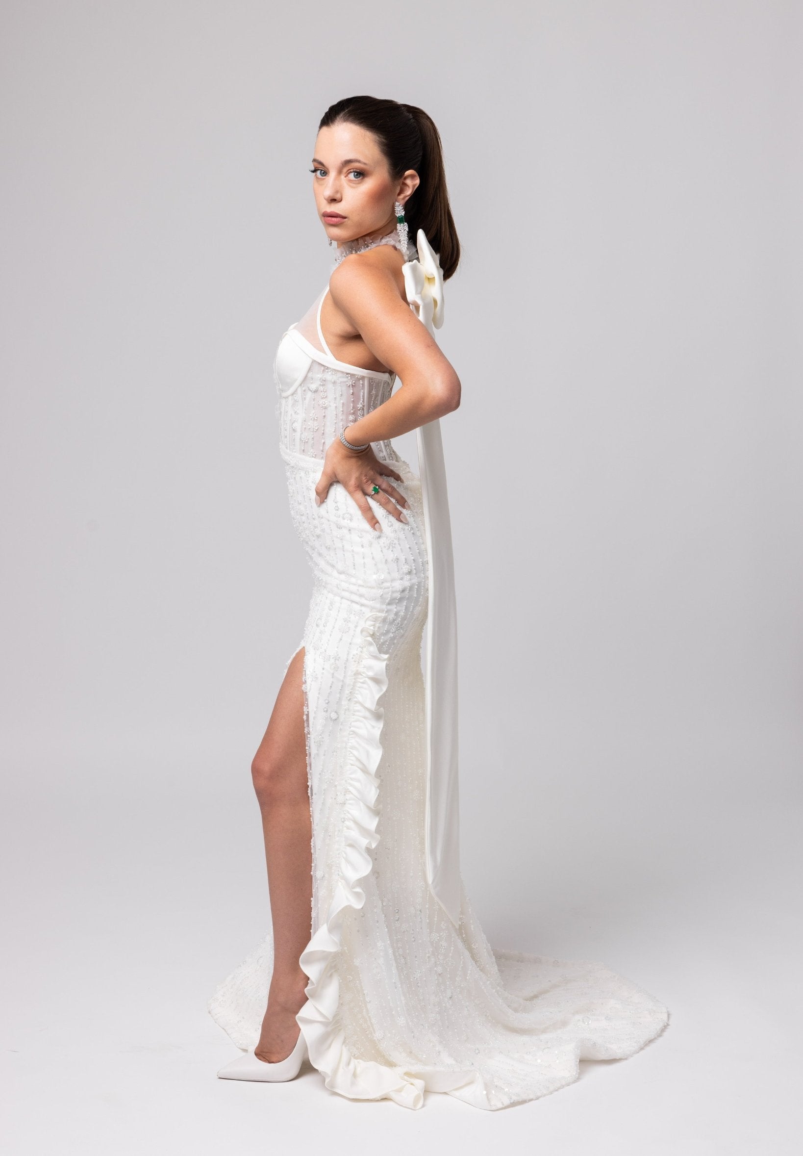 Off-white beaded Italian satin gown, halter jeweled neckline with large cascading double bow in the back.