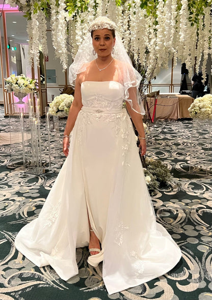 Off-white strapless Italian satin gown with embroidered lace detail; embroidered dramatic long detachable train. 