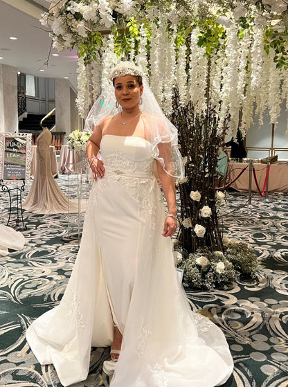 Off-white strapless Italian satin gown with embroidered lace detail; embroidered dramatic long detachable train. 